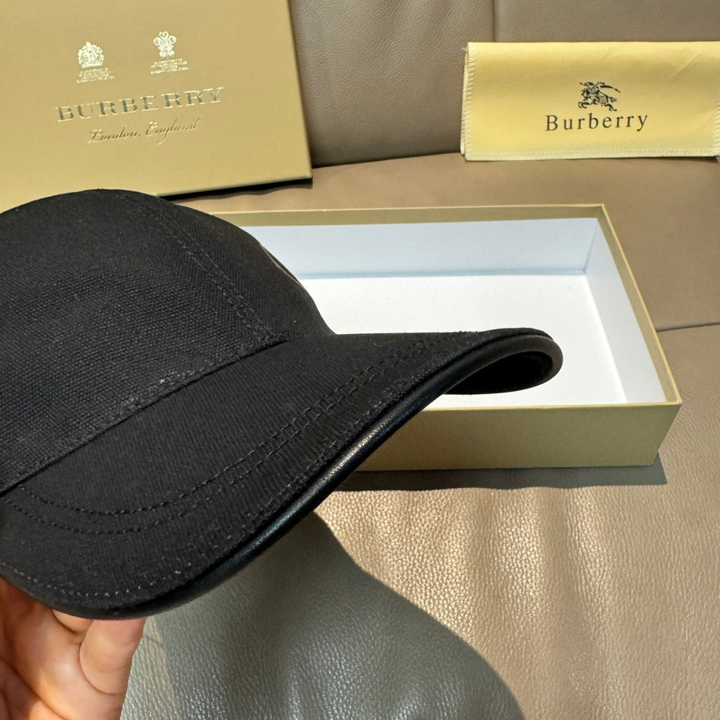Black Burberry baseball cap brim and side seam detail.
