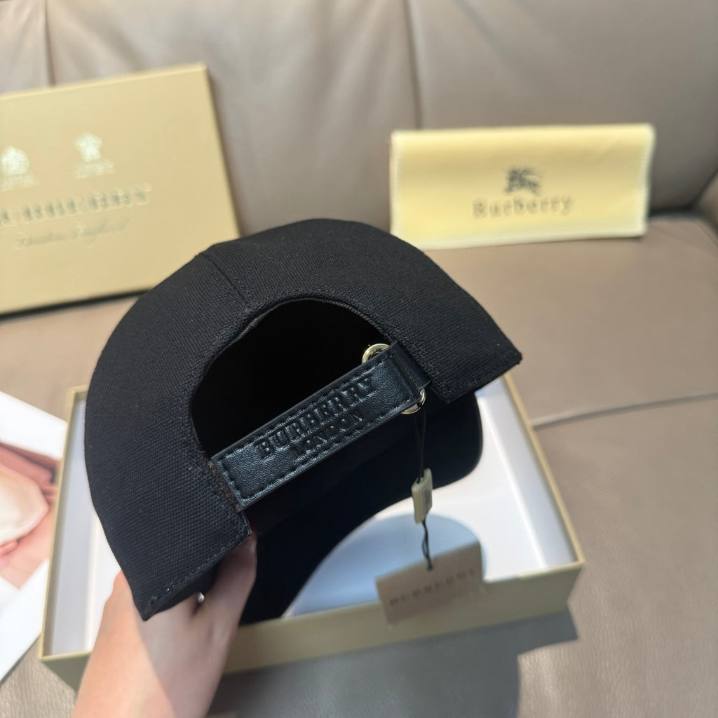Black Burberry baseball cap with adjustable strap and metal buckle on the back.