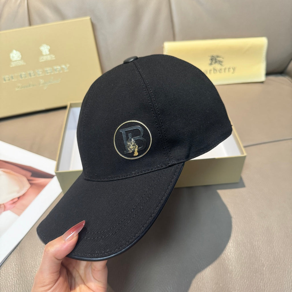 Black Burberry baseball cap with front logo patch and curved brim.