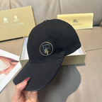 Black Burberry baseball cap with front logo patch and curved brim.