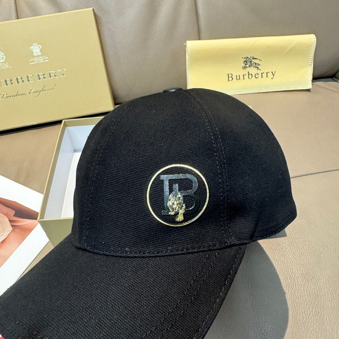 Black Burberry baseball cap with front round logo patch in close-up.