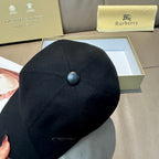 Black Burberry baseball cap with top button detail and stitched panels.