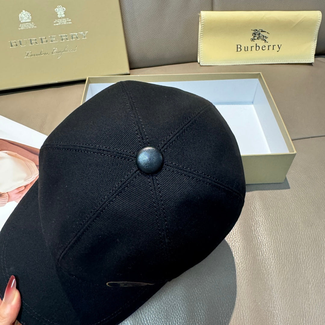 Black Burberry baseball cap with top button detail and stitched panels.