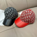 Two Dior caps: black monogram cap and red monogram cap with red leather brim