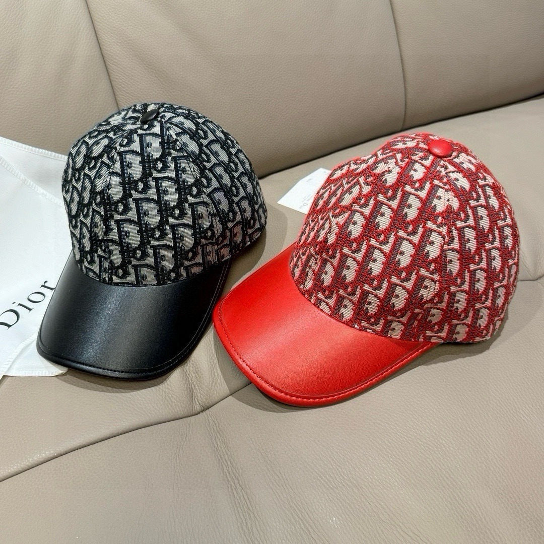 Two Dior caps: black monogram cap and red monogram cap with red leather brim