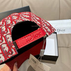 Dior monogram cap with interior black lining and red leather side strap detail