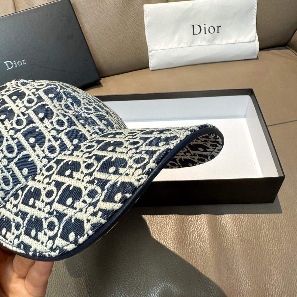 Navy logo cap underside brim view, curved edge and patterned fabric close-up.