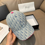 Light blue monogram baseball cap with pink button detail on top