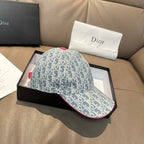 Light blue monogram baseball cap shown from the side with pink-trim brim edge