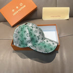 Louis Vuitton baseball cap in green monogram print with curved brim, angled view