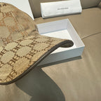 Monogram baseball cap brim close-up in tan and dark brown patterned fabric