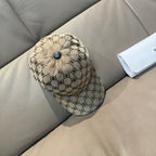 Monogram baseball cap with curved brim, tan pattern and small blue button