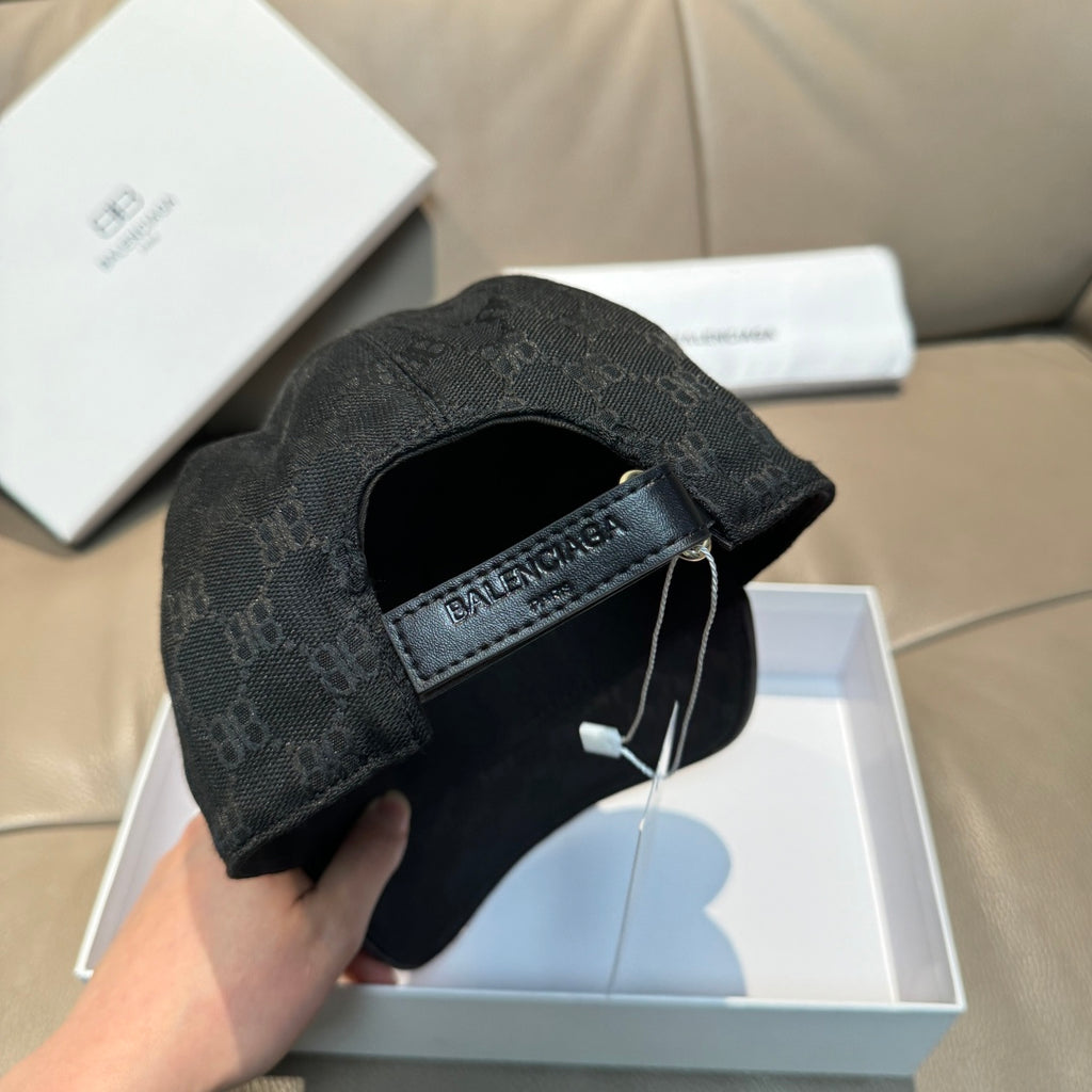 Balenciaga cap with dark monogram fabric, fabric strap label and hanging tag