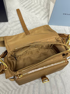 Tan handbag with open front pocket and gold zipper trim, interior view