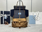 Tan handbag with top handles, gold chain strap, and front flap with triangle logo