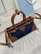 Prada denim and leather mini handbag with top handle, flap strap, and gold hardware