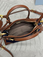 Prada handbag open top view with brown interior lining and tan leather handles