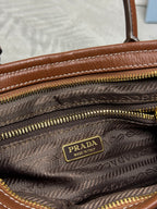Prada denim handbag interior lining with Prada logo patch and multiple gold zippers