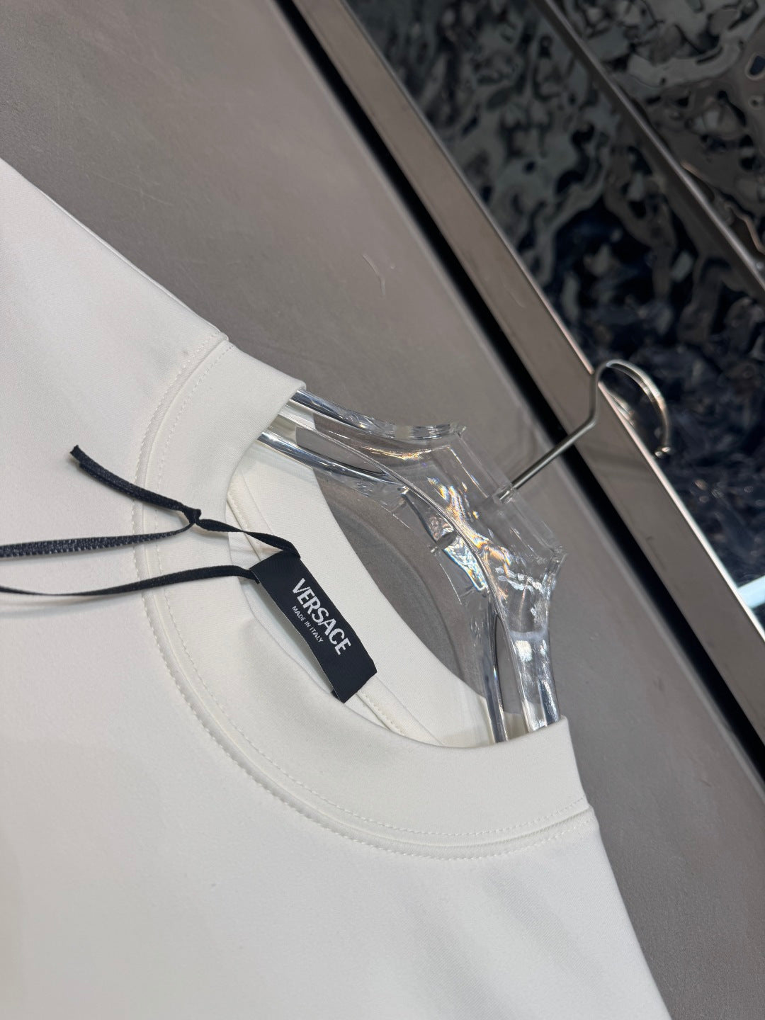 White long-sleeve T-shirt with collar detail and Versace neck label