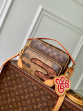 Louis Vuitton monogram canvas mini bag with orange trim, zipper top and charm detail