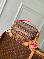 Louis Vuitton monogram canvas mini bag with orange trim, zipper top and charm detail