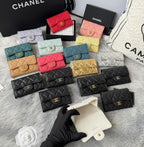 Small quilted flap wallet bags assortment in red, pink, yellow, teal, gold, gray, and black.