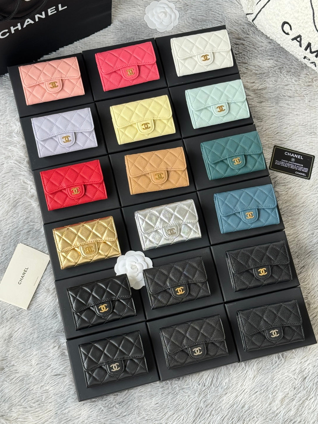 Small quilted flap wallet bags set with mixed colors, including pink, white, yellow, teal, and black.
