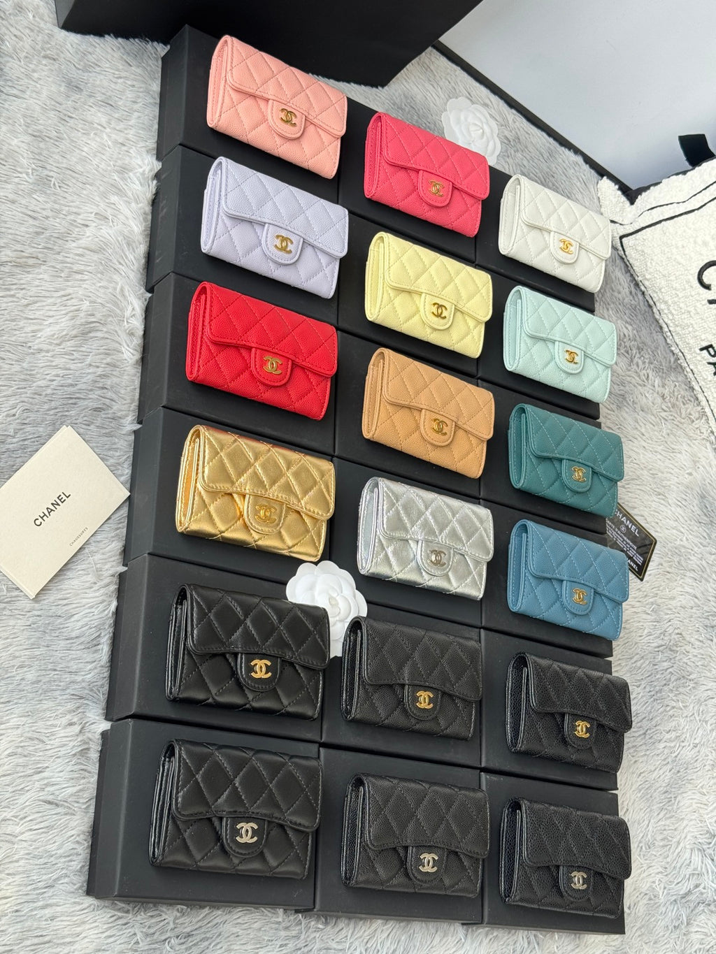 Small quilted flap wallet bags set in pink, red, white, yellow, gold, teal, and black.
