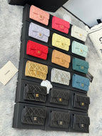 Small quilted flap wallet bags set in pink, red, white, yellow, gold, teal, and black.