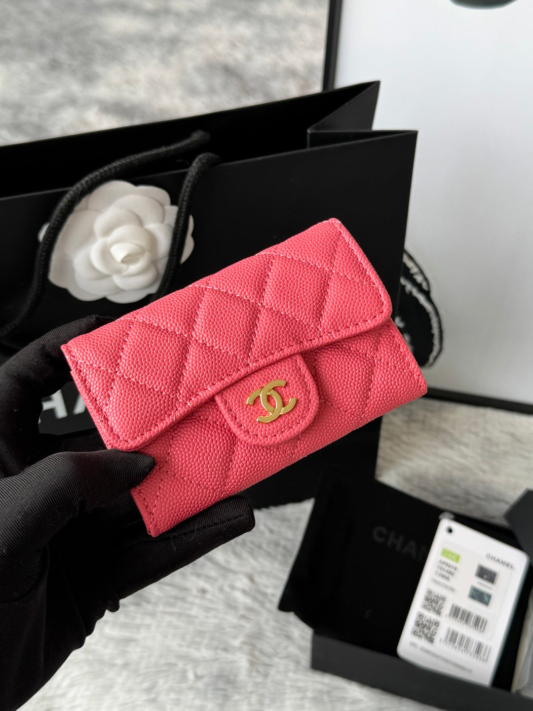 Quilted flap bag with gold logo, bright red textured leather, magnetic snap closure.
