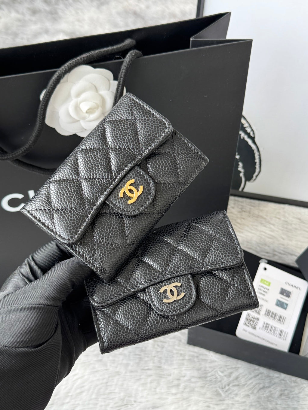 Dark gray quilted flap small bag with gold clasp and interlocking logo