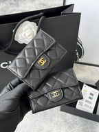 Dark gray quilted flap small bag with gold clasp and interlocking logo