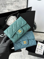 Teal blue quilted flap small bag with gold logo clasp and chain strap