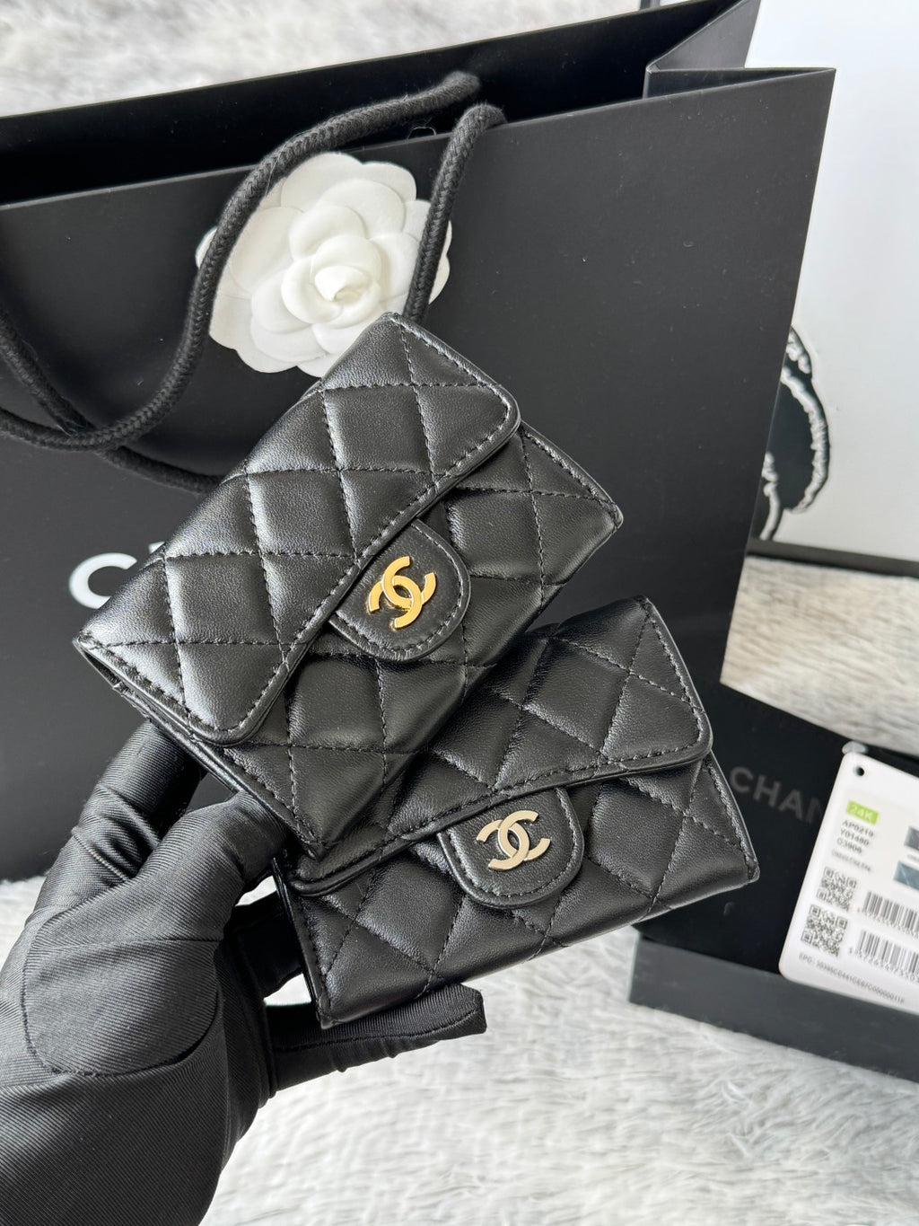 Black quilted flap small bag with gold interlocking logo clasp