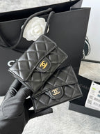 Black quilted flap small bag with gold interlocking logo clasp