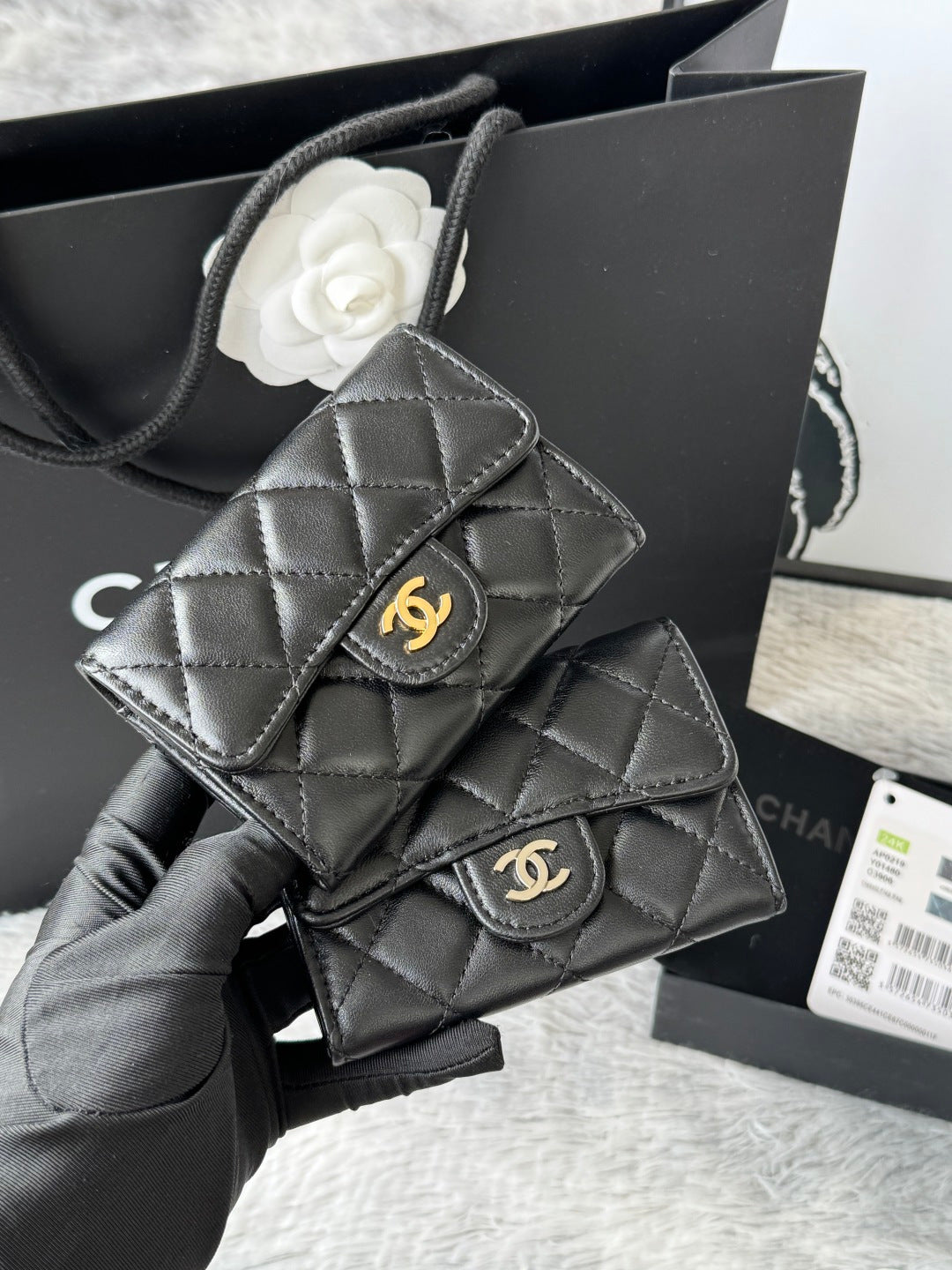 Black quilted flap small bag with gold interlocking logo clasp