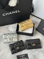 Quilted mini flap bags: gold and silver with logo emblem, plus two black bags