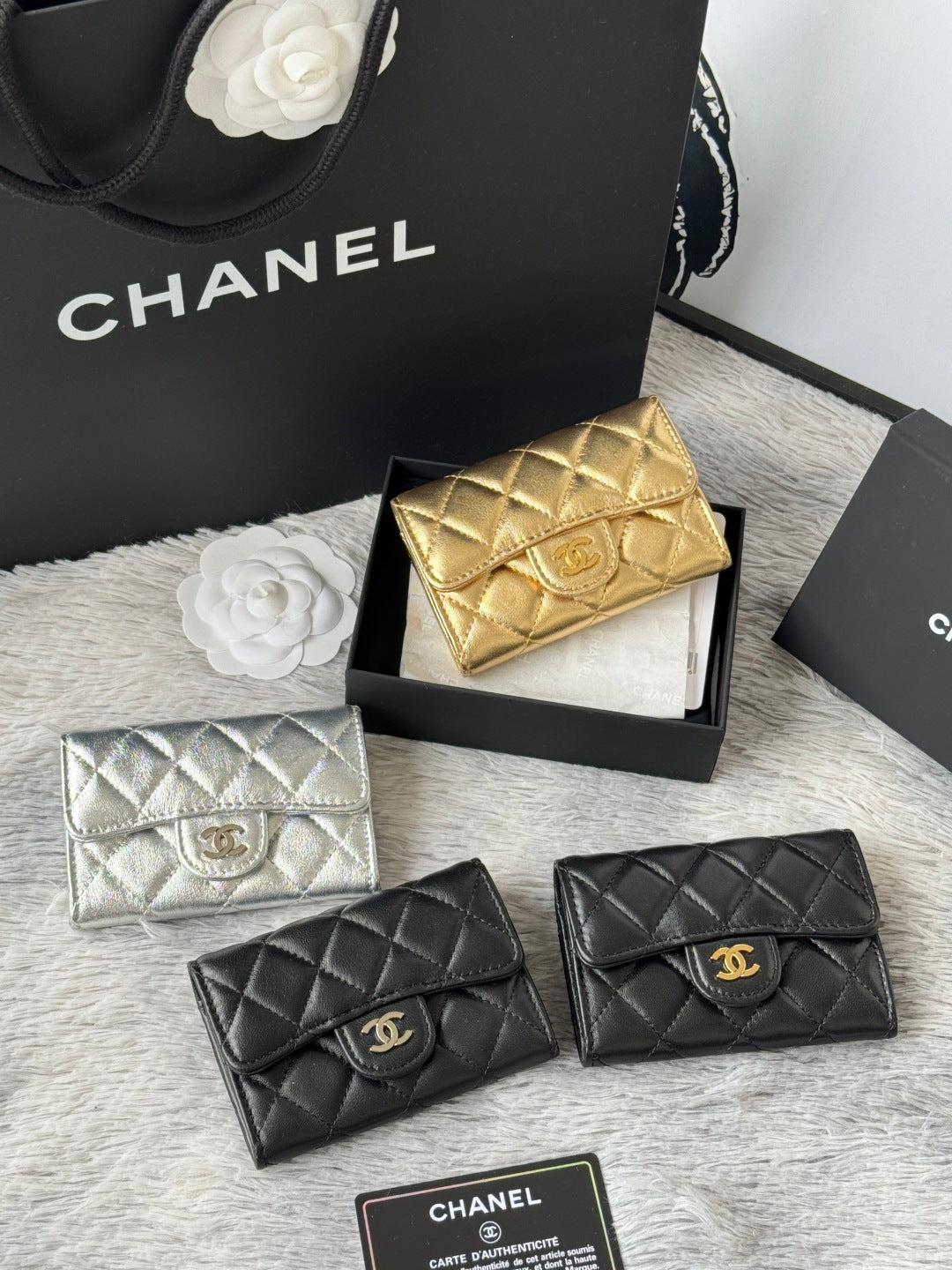 Quilted mini flap bags: gold and silver with logo emblem, plus two black bags