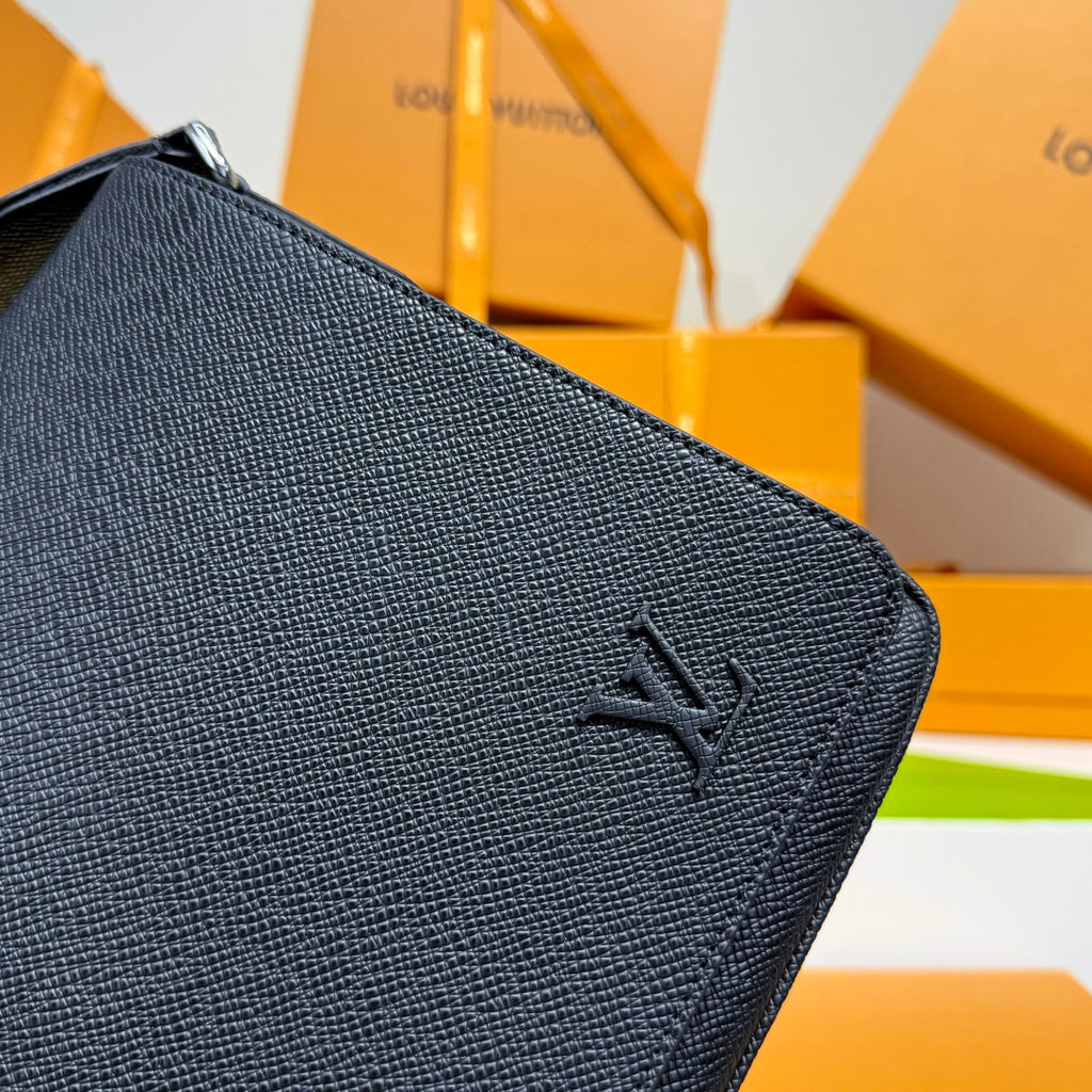 Navy textured leather bag front corner with LV logo and metal zipper pull.