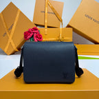 Louis Vuitton crossbody bag in textured dark blue with front LV logo and flap.