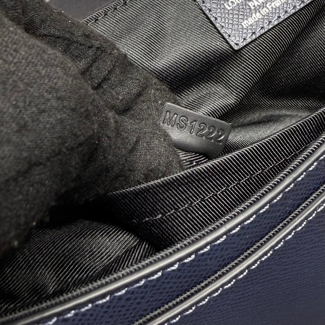 Men's Louis Vuitton bag interior, embossed code on lining near stitching