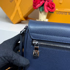 Louis Vuitton blue bag with front zipper and silver pull detail.