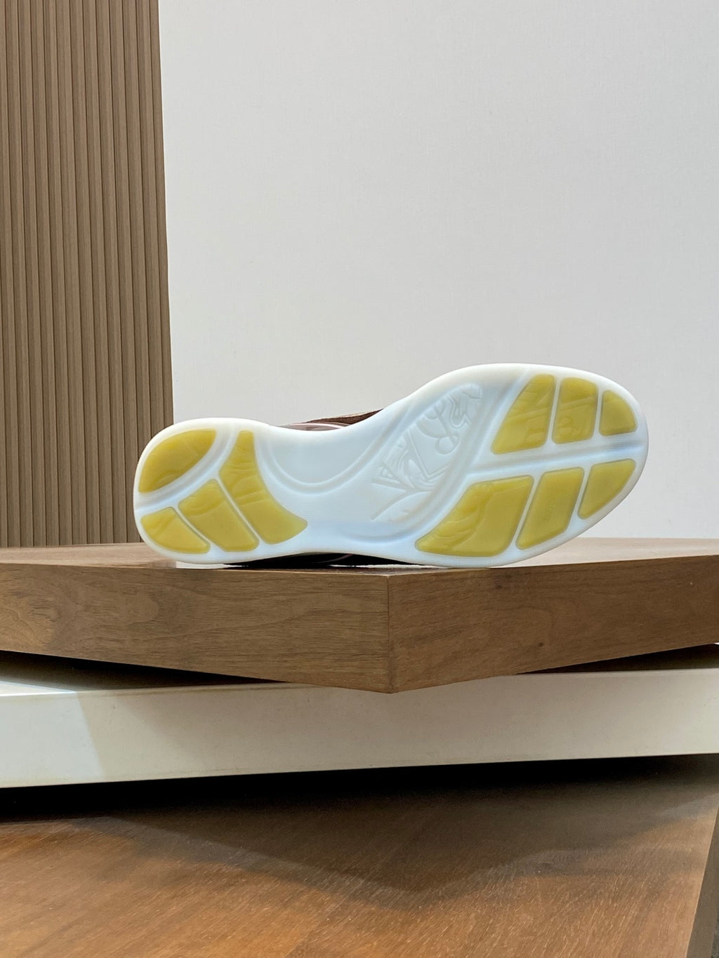 Burberry sneaker outsole with white tread and yellow rubber panels