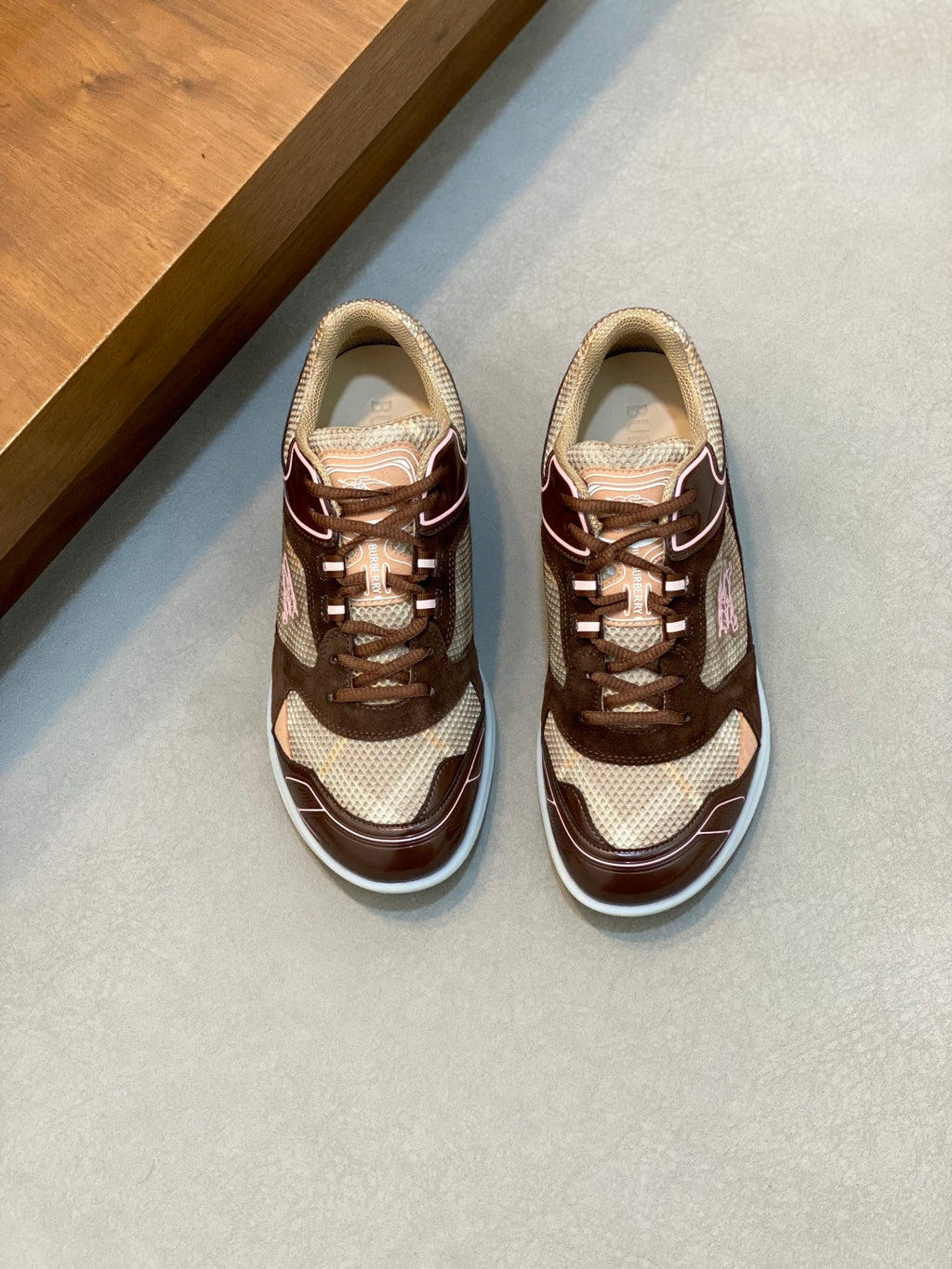 Burberry lace-up sneakers in beige and dark brown with white soles, shown side by side