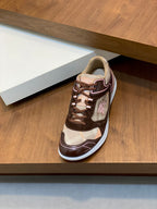 Burberry lace-up sneakers on a shelf, brown and beige uppers with white outsole
