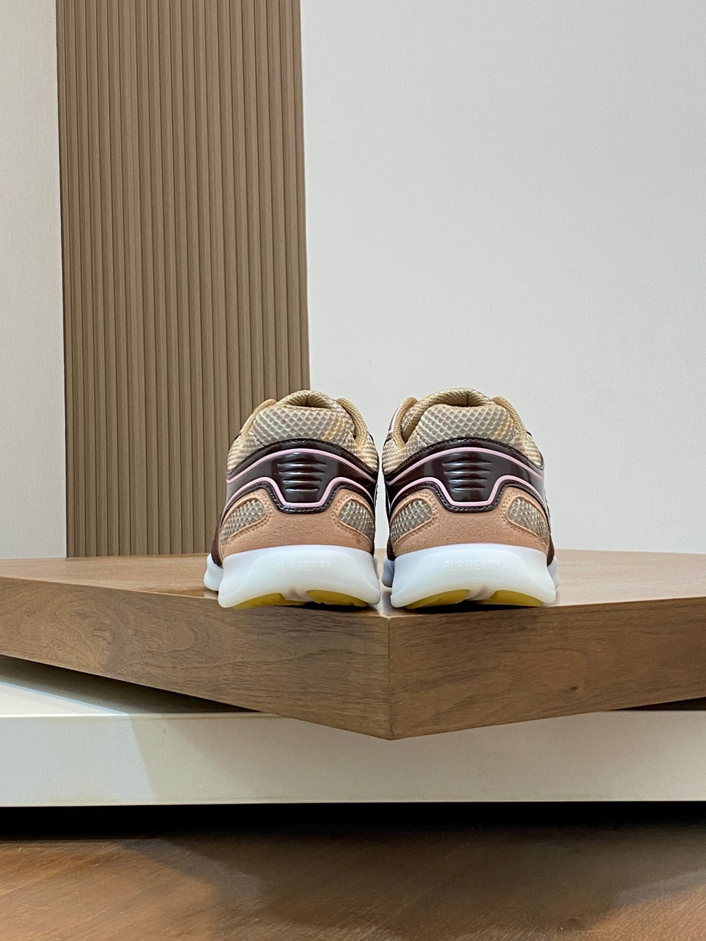 Burberry sneakers from the back, beige uppers with brown heel accents and white sole