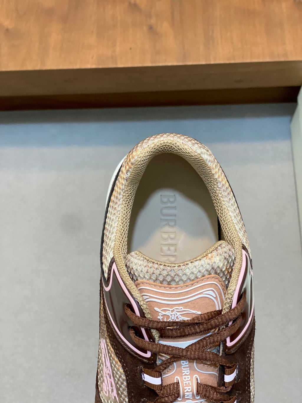 Burberry lace-up sneaker close-up on upper, beige mesh with brown trim