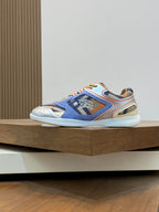 Burberry low-top sneakers, blue upper with orange and yellow trim, lace-up design