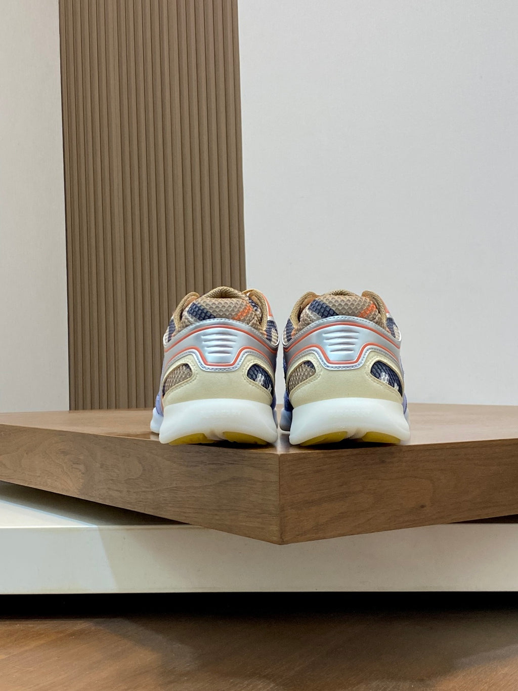 Burberry sneakers with blue uppers and multicolor details, showing heel and back