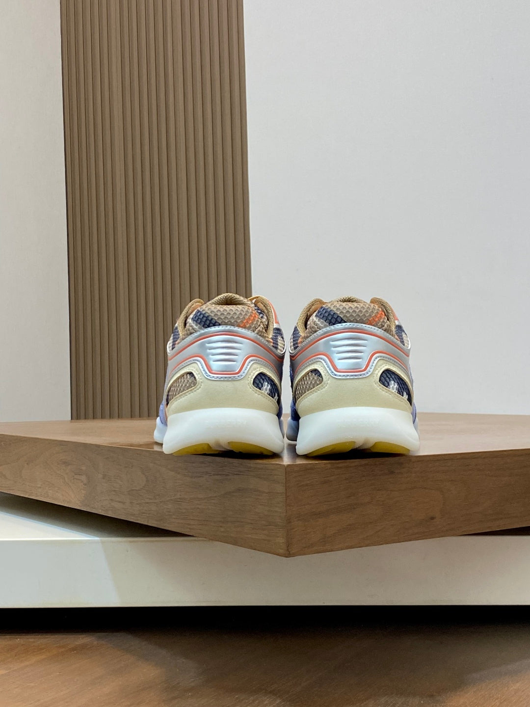 Burberry sneakers with blue uppers and multicolor details, showing heel and back